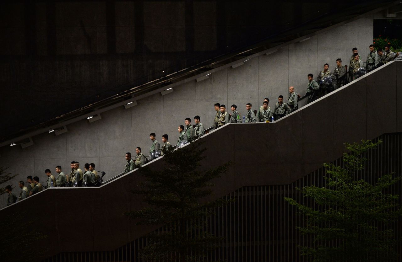 Police walk down a stairwell as demonstrators gather outside government buildings in Hong Kong on September 29.