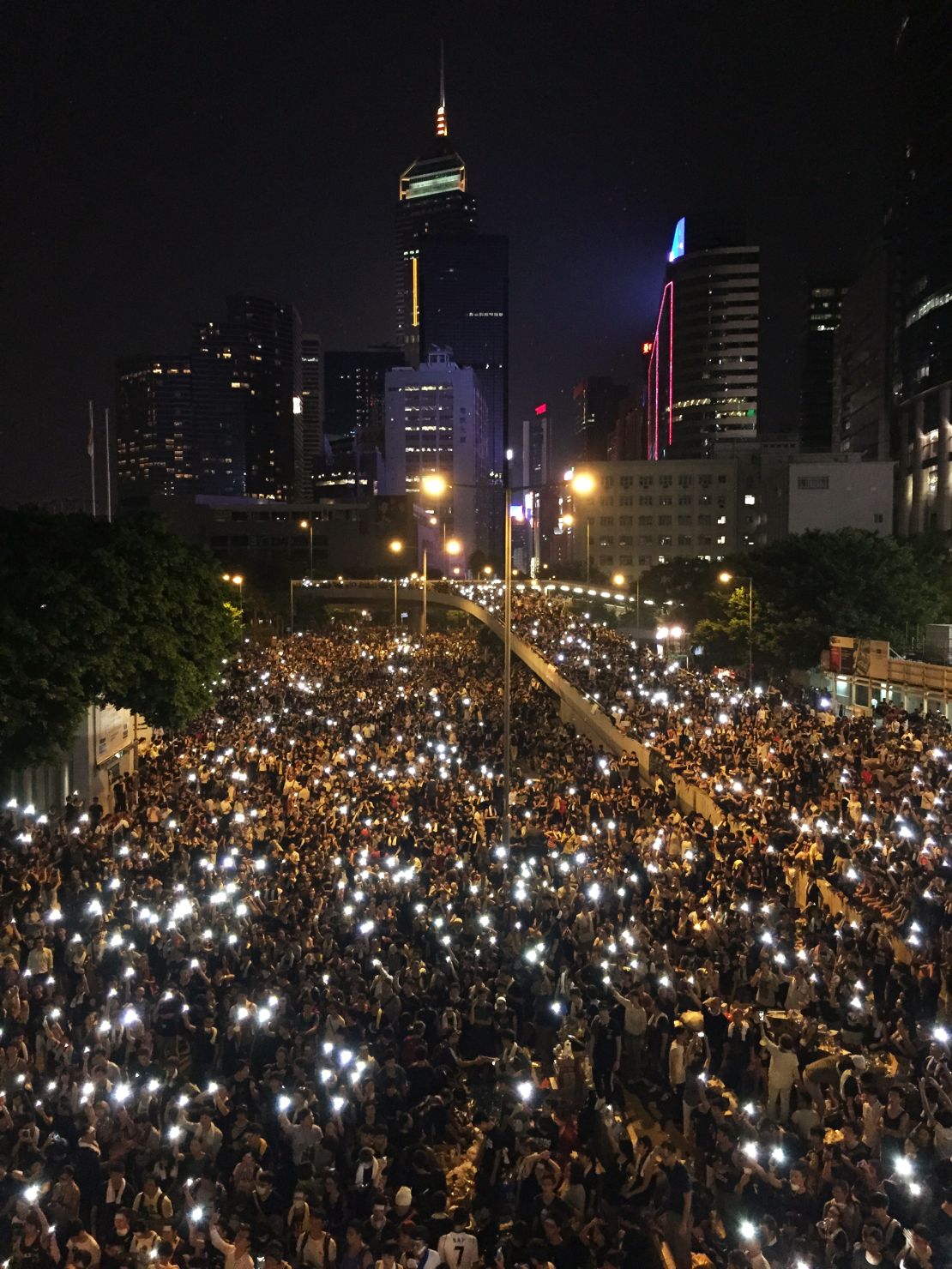 Photographed from above, the glowing screens of mobile phones held aloft by the sea of protesters' have created an enduring image of solidarity.