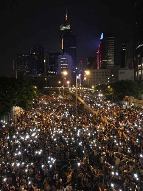 Photographed from above, the glowing screens of mobile phones held aloft by the sea of protesters' have created an enduring image of solidarity.