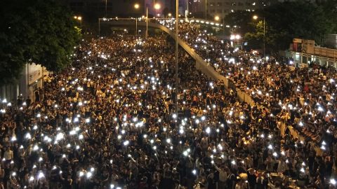 Photographed from above, the glowing screens of mobile phones held aloft by the sea of protesters' have created an enduring image of solidarity.