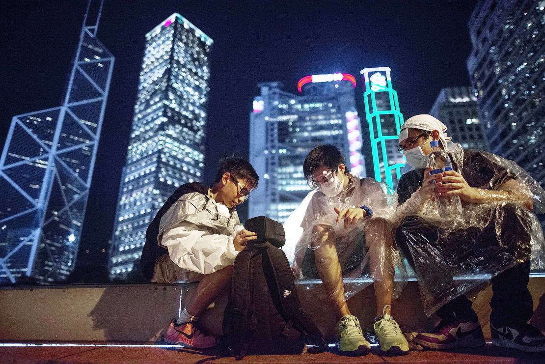 Protesters wear goggles and plastic ponchos to protect themselves from tear gas. Demonstrators were gassed by Hong Kong police on Sunday. 