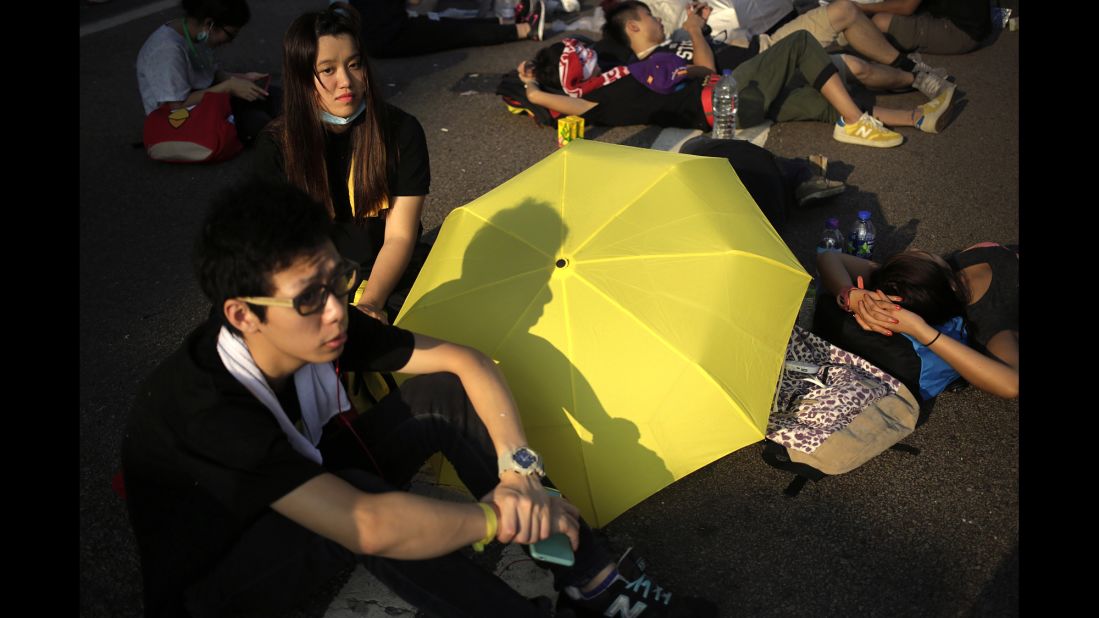Student activists rest on a road in Hong Kong on September 30, near the government headquarters where pro-democracy activists have gathered.
