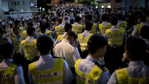Police officers stand off with protesters next to the Hong Kong police headquarters on September 29.