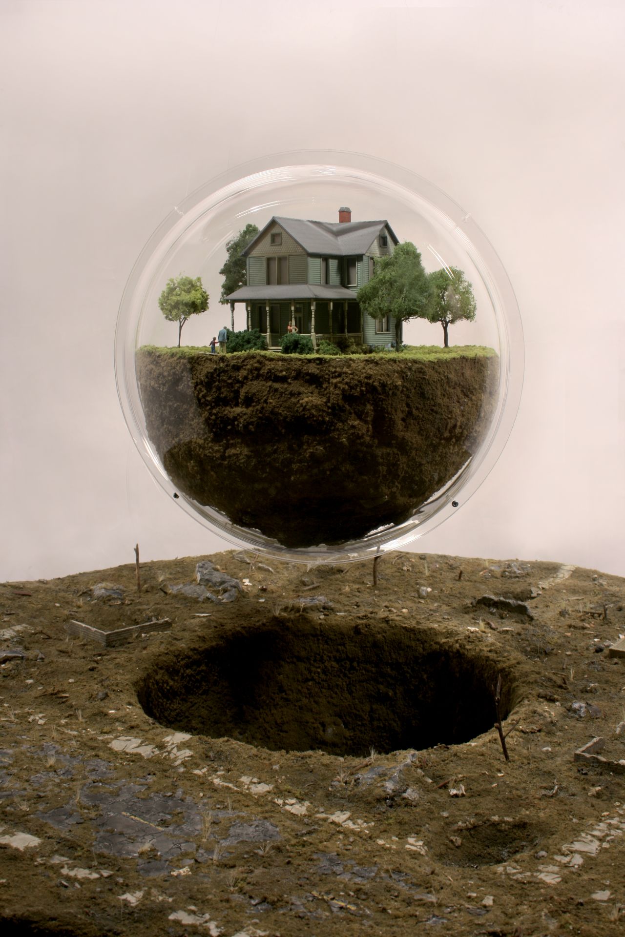 <em>Proxy (Haven Ln), Thomas Doyle, 2012</em><br /><br />This American artist creates intricate worlds encased under glass domes or bell jars, as if captured by a collector. Crafted at a scale of 1:43 -- sometimes smaller -- these scenes are somehow familiar, depicting the suburban landscapes we are accustomed to seeing in Hollywood movies, with white picket fences and immaculate lawns, but in moments after catastrophe has struck.