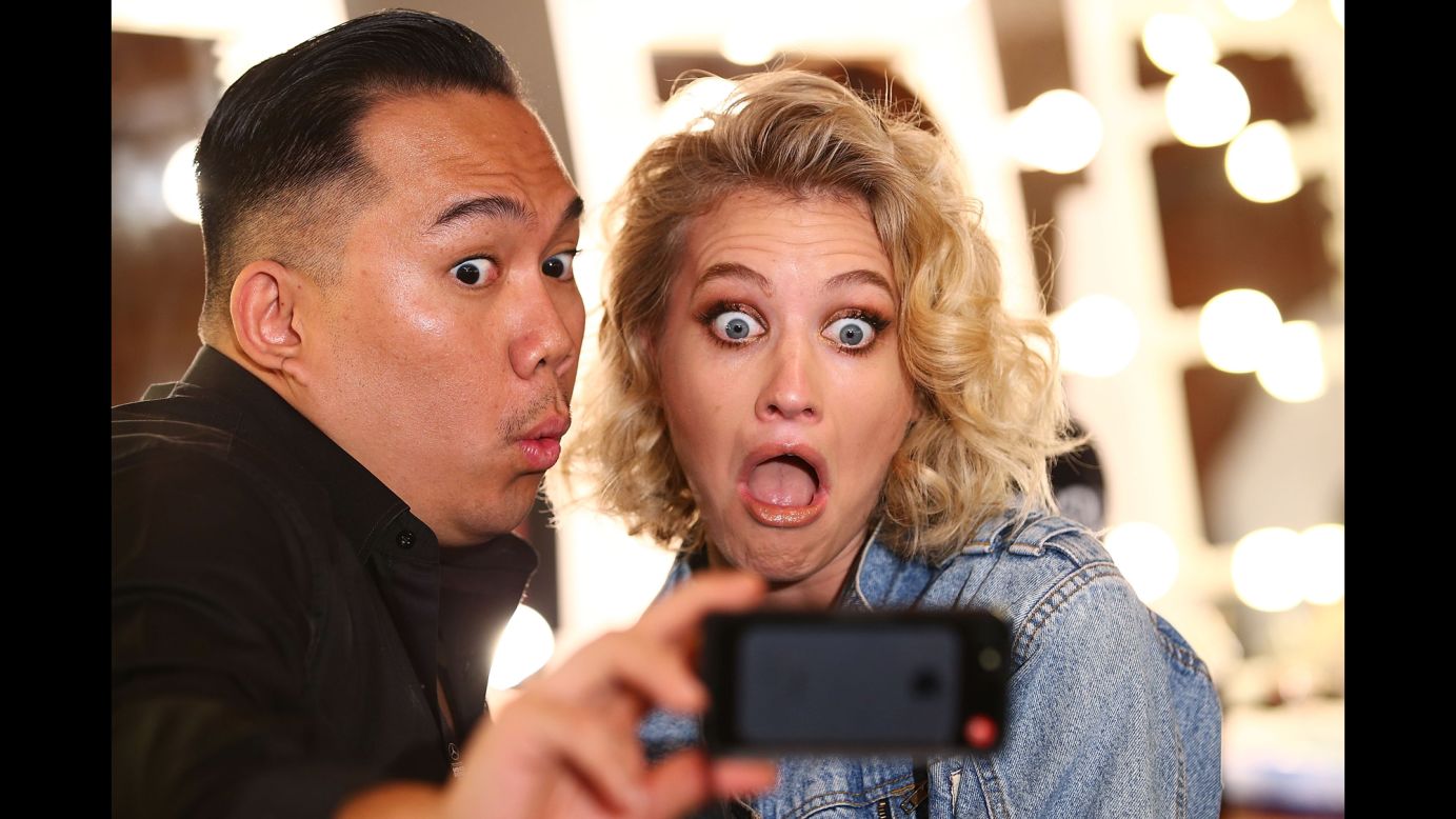 A makeup artist and a model take a selfie backstage at a fashion show in Sydney on Thursday, September 25.