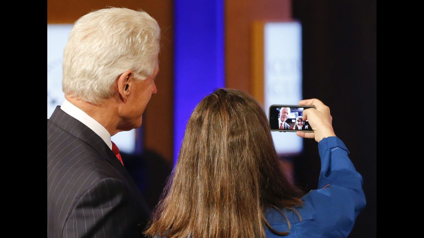 Former U.S. President Bill Clinton poses for a selfie with astronaut Cady Coleman on Wednesday, September 24, in New York. Coleman was going to send the photo to astronaut Reid Wiseman, who is aboard the International Space Station.