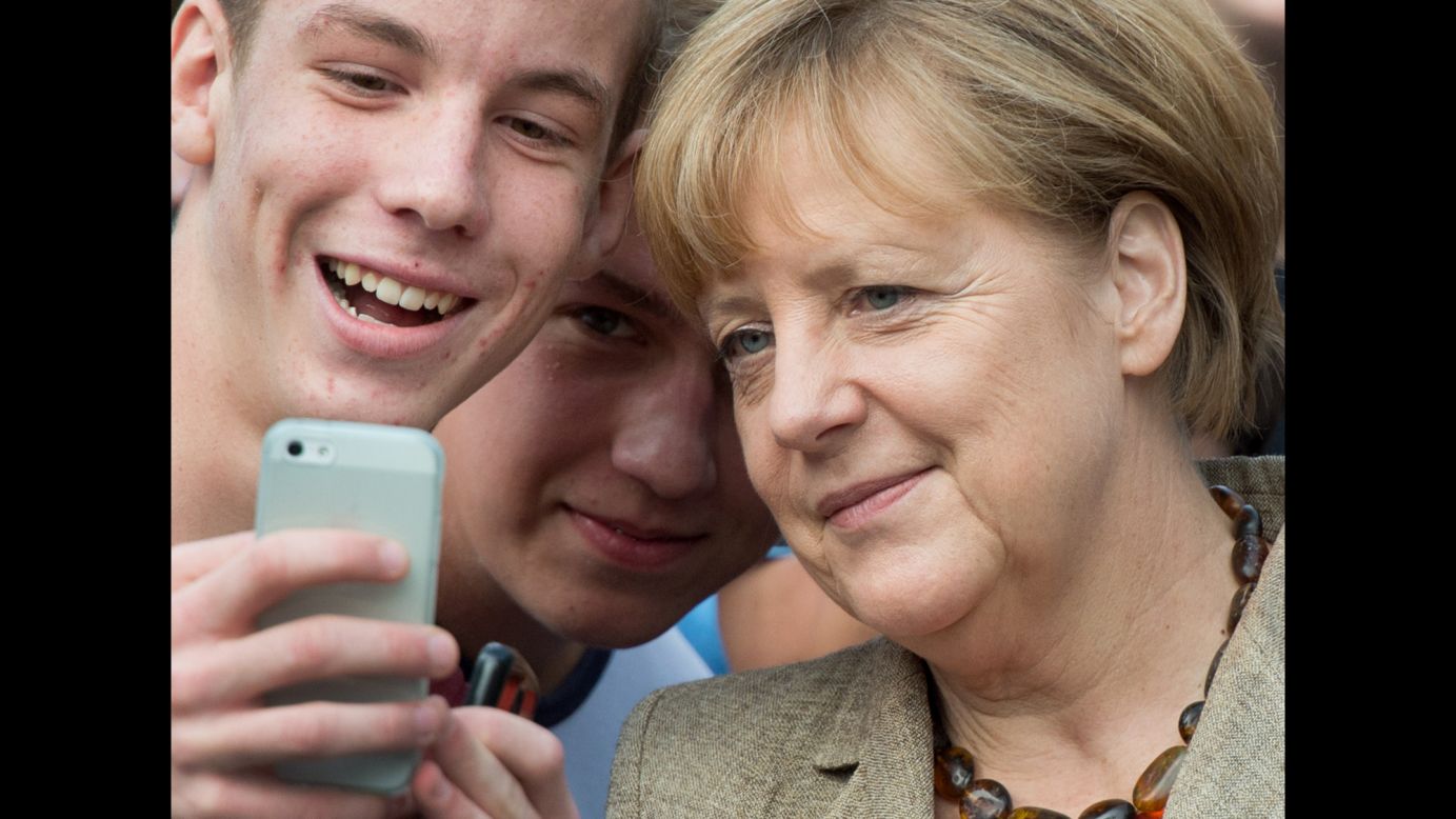 German Chancellor Angela Merkel poses with grammar school students in Gross-Gerau, Germany, on Tuesday, September 30.