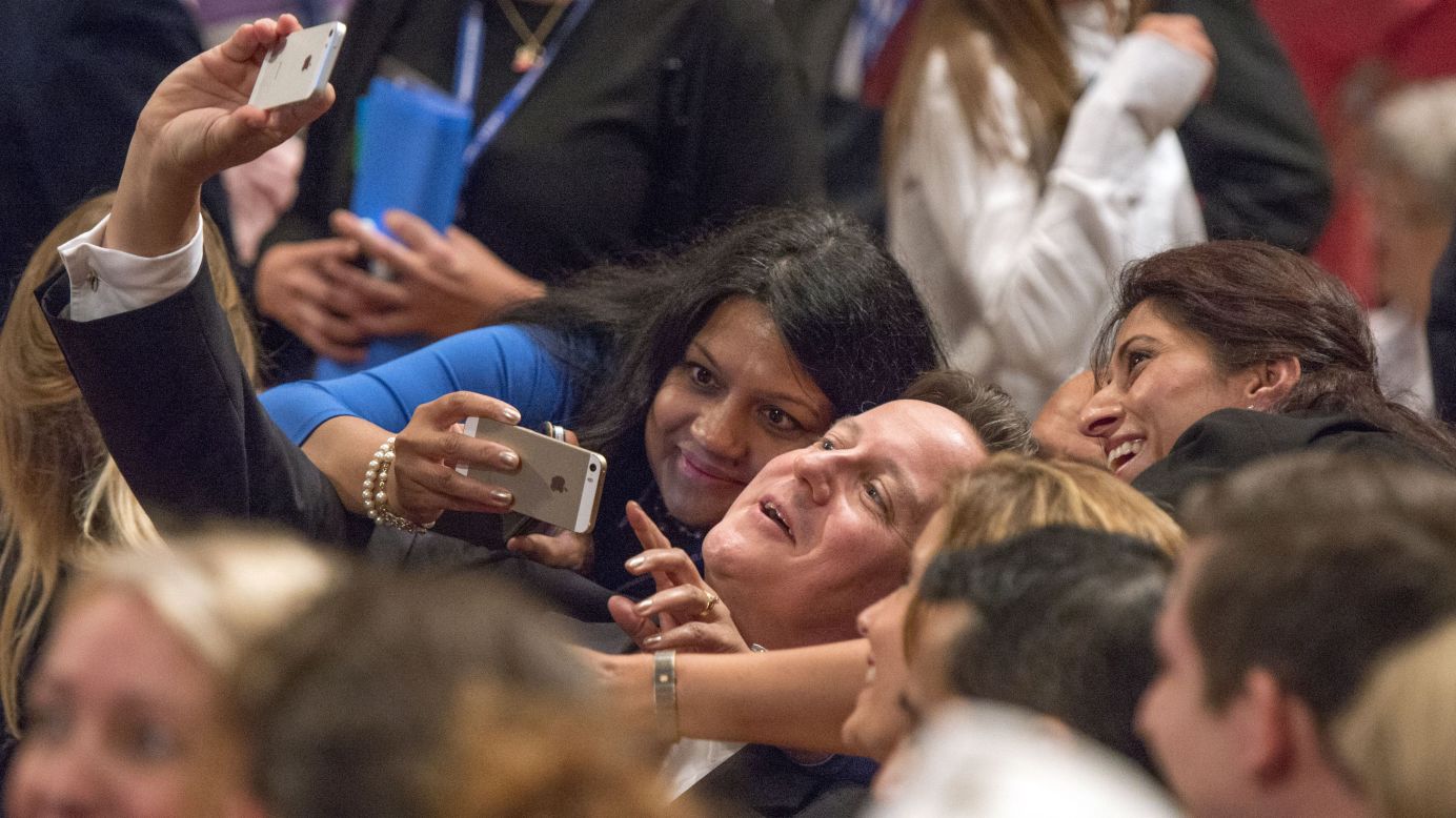 British Prime Minister David Cameron takes a selfie with delegates at the Conservative Party's annual conference on Tuesday, September 30, in Birmingham, England.