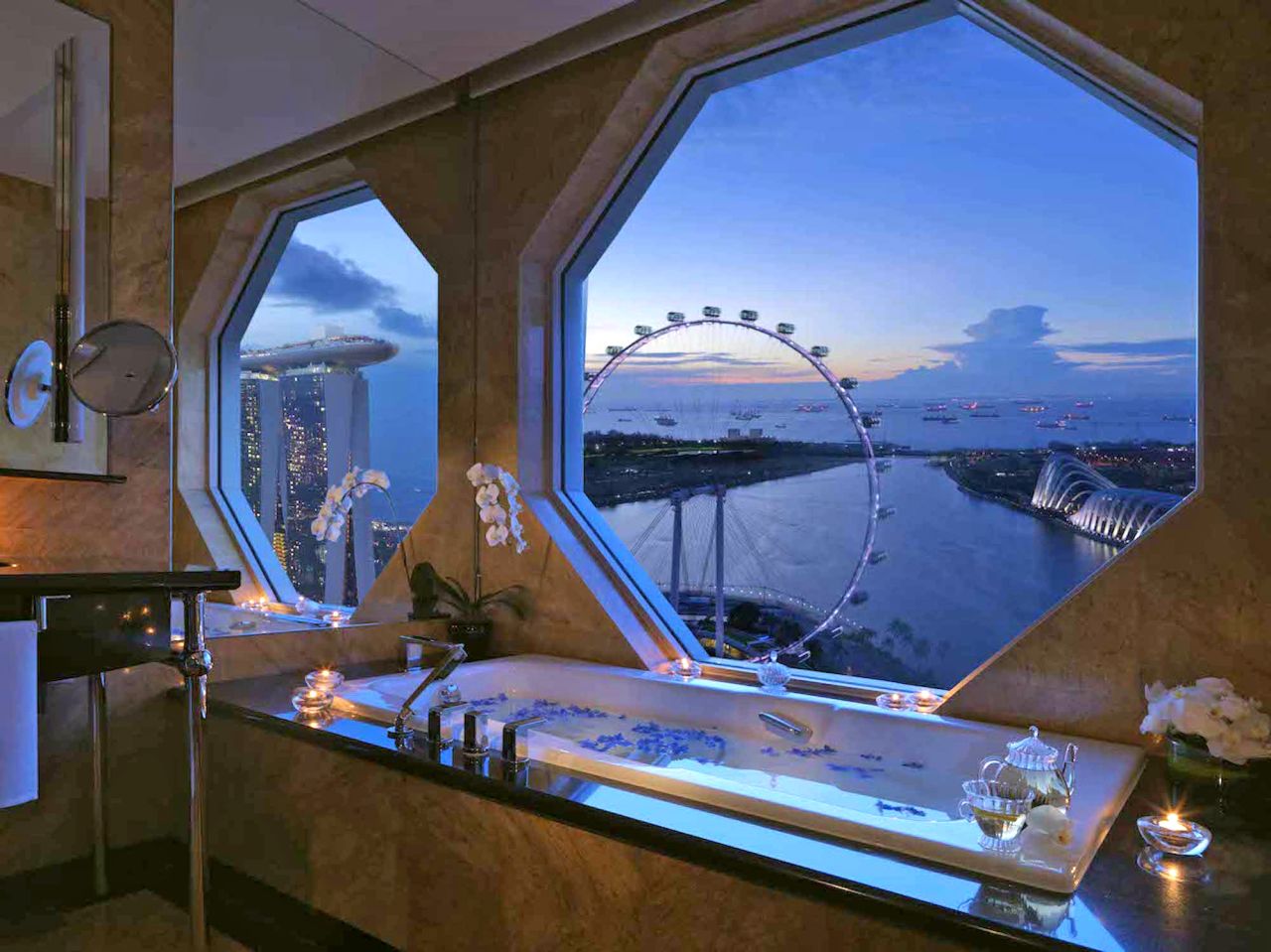 Marble bathrooms in the Ritz-Carlton, Millenia Singapore's bay view rooms overlook the iconic Marina Bay Sands, Singapore Flyer and city skyline.