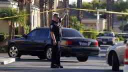 A police officer stands by the scene of a shooting in Bell Gardens, Calif., Tuesday, Sept. 30, 2014. Authorities say Mayor Daniel Crespo, of the Los Angeles suburb of Bell Gardens, has been shot to death and his wife is in custody. (AP Photo/Nick Ut)