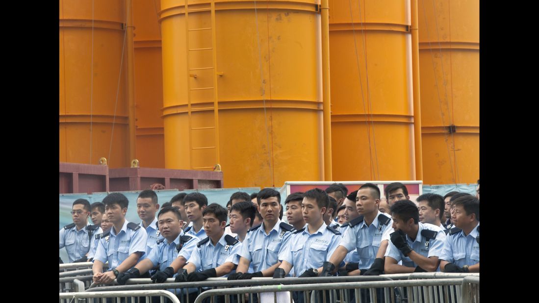 Hong Kong police stand guard outside the flag-raising ceremony October 1.