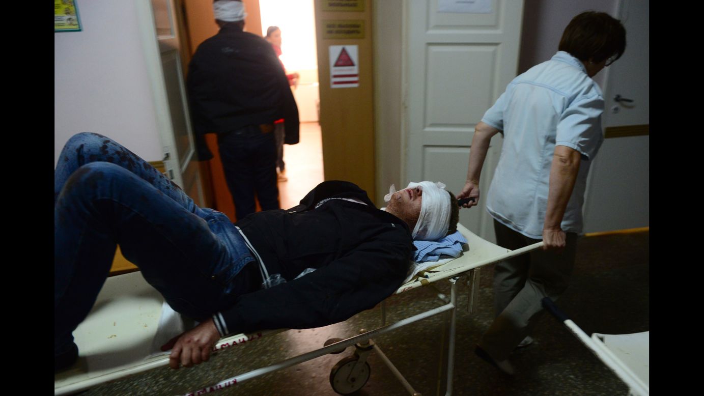 An injured man is transported at a hospital after shelling in Donetsk on Wednesday, October 1.