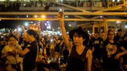 A protester waves her cell phone in the air outside the Hong Kong Government Complex on October 1.