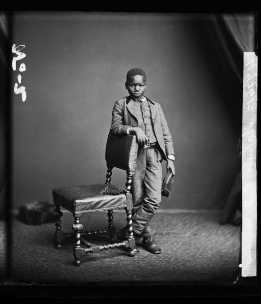 Poised, elegant and regal - never before seen images depicting black people in Britain prior to 1938 are on display at Rivington Place gallery, as part of the Black Chronicles II exhibition. Kalulu, seen here, is often pictured with explorer Sir Henry Morton Stanley as 'his boy'. Here, he holds his own with striking poise. <br /><br />Kalulu (Ndugu M'Hali). London Stereoscopic Company, 8 August 1872. 