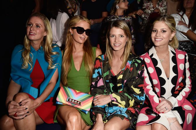 Paris Hilton and Nicky Hilton make an appearance at the Valentino show, snuggling next to Helena Bordon and Lala Rudge. 
