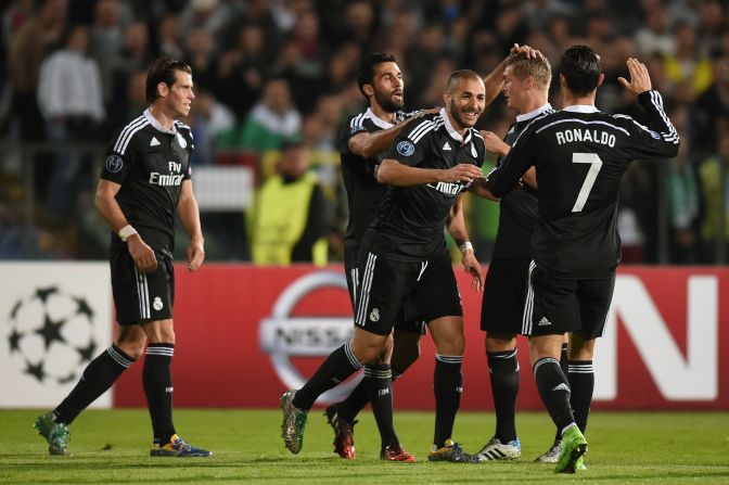 Benzema is congratulated on his winner as Real breathed a sigh of relief to come away with all three points.