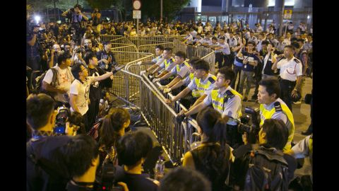 Protesters confront police outside the government complex in Hong Kong on October 2.