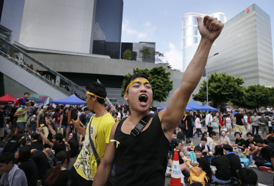 A pro-democracy activist shouts slogans on a street near the government headquarters on Wednesday, October 1.