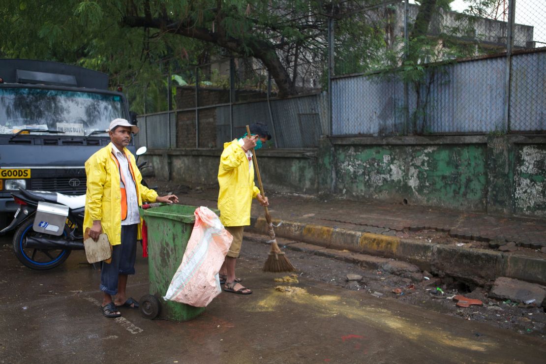 Ganesh Shinde (right) with his colleague doing their job on the streets of Mumbai.