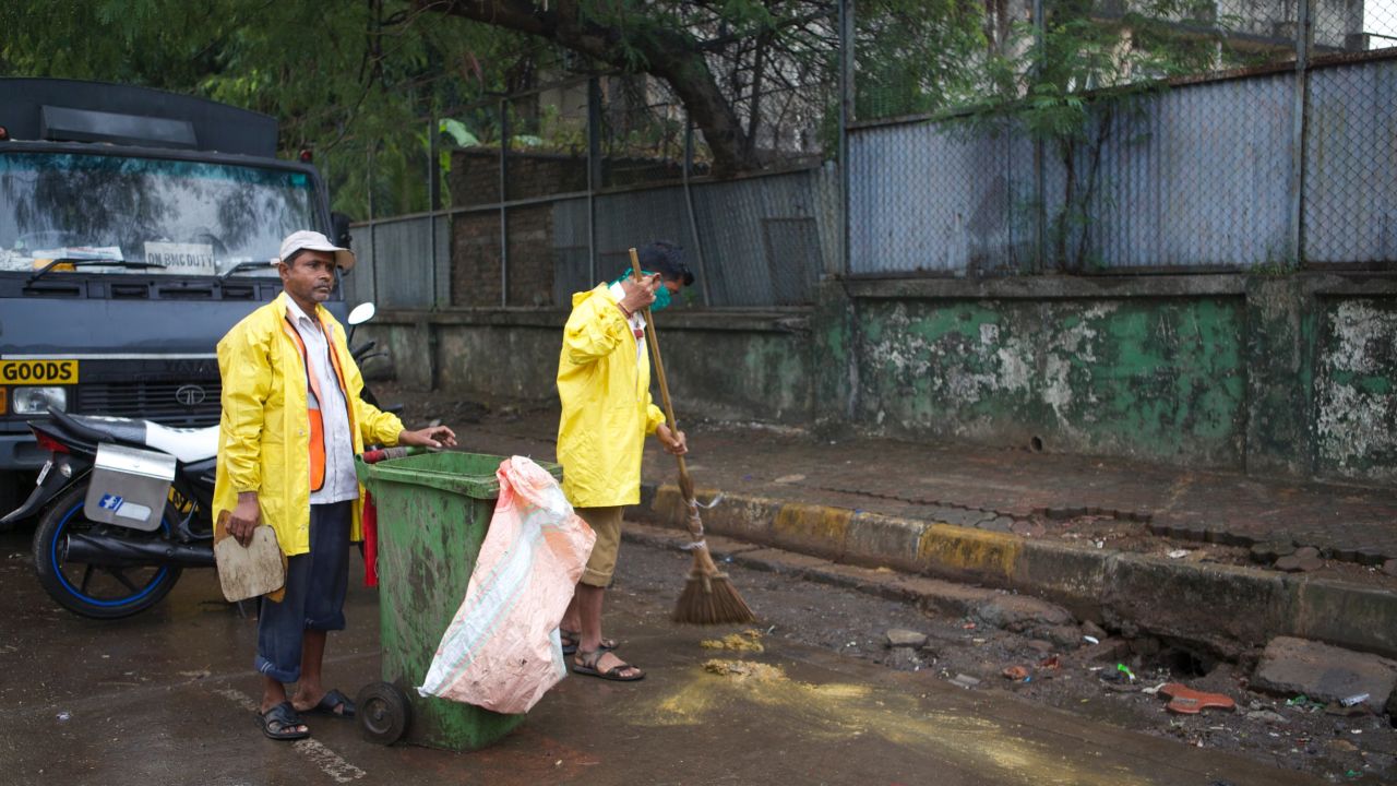 Ganesh Shinde (right) with his colleague doing their job on the streets of Mumbai.