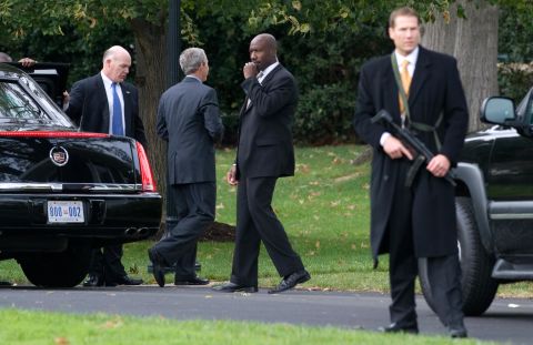 Clancy holds the door for President George W. Bush in October 2008.