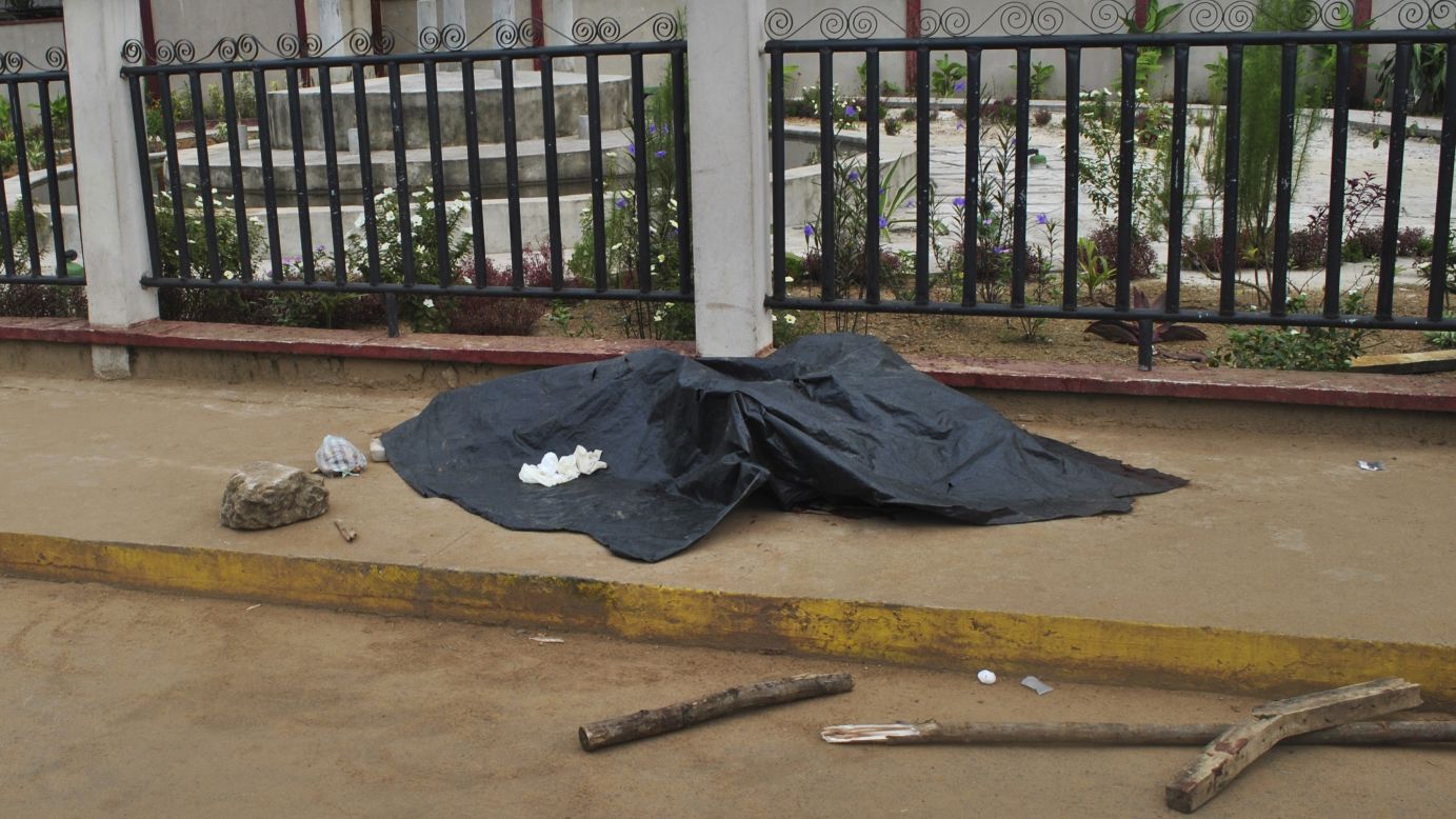 A man's dead body is covered with a tarp before being tested for the Ebola virus Saturday, September 27, in Monrovia, Liberia. Health officials say <a href="http://www.cnn.com/2014/04/04/world/gallery/ebola-in-west-africa/index.html">the Ebola outbreak in West Africa</a> is the deadliest ever. More than 3,000 people have died, according to the World Health Organization.
