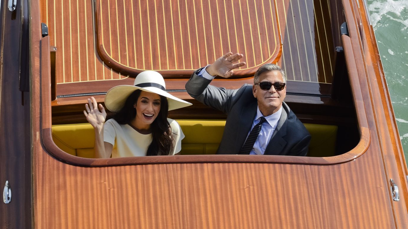 Actor George Clooney and his wife, lawyer Amal Alamuddin, wave from a boat after their civil wedding ceremony Monday, September 29, in Venice, Italy. The day before, a private ceremony <a href="http://www.cnn.com/2014/09/27/showbiz/gallery/clooney-wedding/index.html">was attended by some of their celebrity friends.</a>