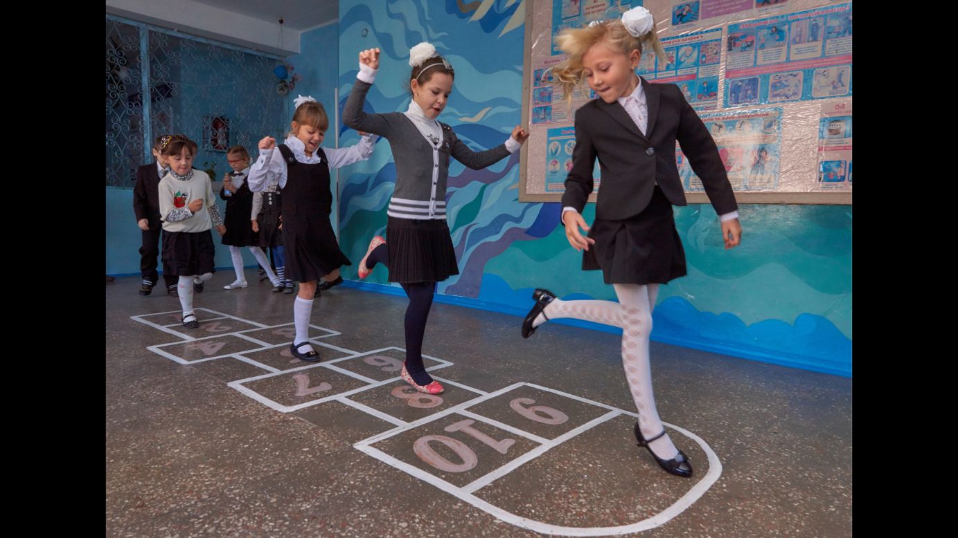 Girls in Donetsk, Ukraine, play hopscotch during a break in school on Wednesday, October 1. The school year had been postponed for a month because of <a href="http://www.cnn.com/2014/08/07/europe/gallery/ukraine-crisis/index.html">the fighting between Ukrainian troops and pro-Russian rebels</a> in the country.