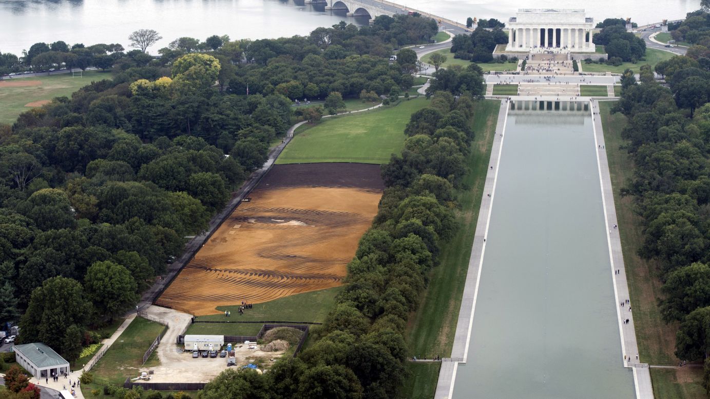 "Out of Many, One," a landscape portrait by artist Jorge Rodriguez-Gerada, appears on the National Mall in Washington on Wednesday, October 1. The 6-acre portrait will be viewable until October 31.