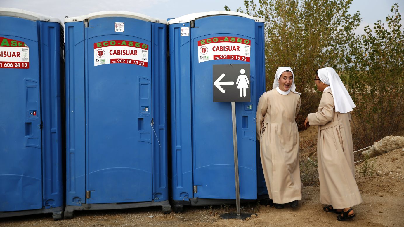 A Catholic nun in Madrid laughs Saturday, September 27, as she comes out of a portable toilet before the start of the beatification ceremony for Bishop Alvaro del Portillo.