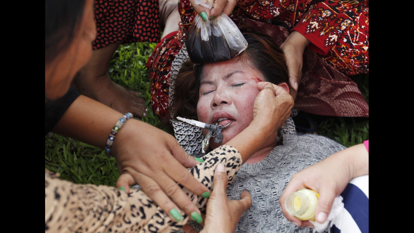 Protesters assist a person who was injured during clashes with police officers Friday, September 26. in Phnom Penh, Cambodia. Australia <a href="http://www.cnn.com/2014/09/26/world/asia/australia-cambodia-refugee-deal/index.html">has struck a multimillion-dollar deal with Cambodia</a> to settle refugees in the Asian nation. But protesters say Cambodia, one of Southeast Asia's poorest nations, is ill equipped to host the asylum seekers.
