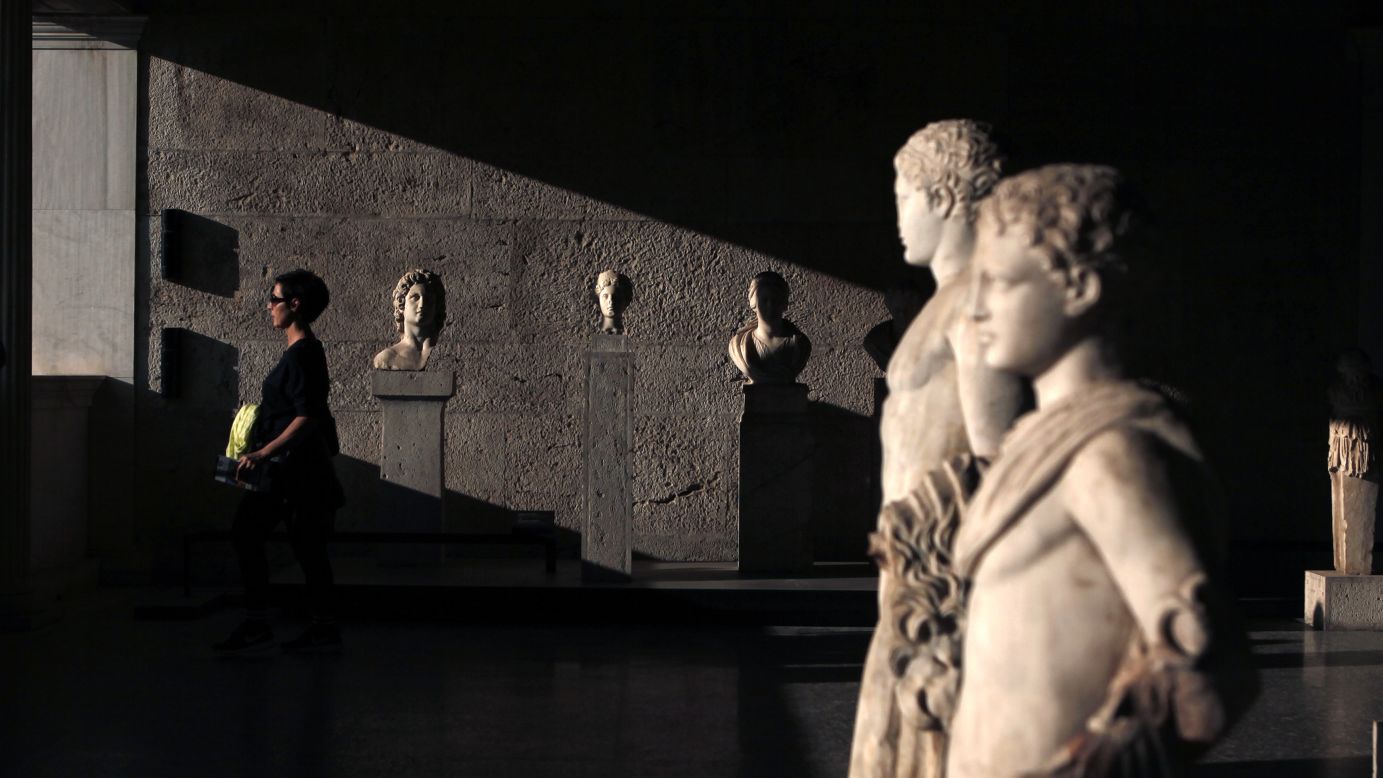 A woman walks among statues and busts at the Roman Agora archaeological site in Athens, Greece, on Monday, September 29.