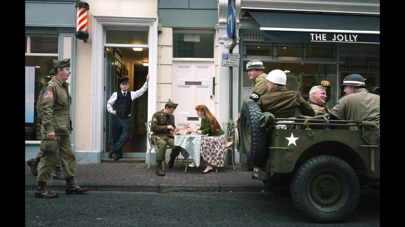 Men dressed as American GIs take part in a World War II-era re-enactment Monday, September 29, outside the Headhunters Barber Shop and Railway Museum in Enniskillen, Northern Ireland. 