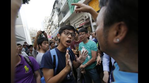 A protester tries to negotiate with angry residents trying to remove barricades blocking streets in Hong Kong's Causeway Bay on October 3. Large crowds opposed to the pro-democracy movement gathered to clear the area.