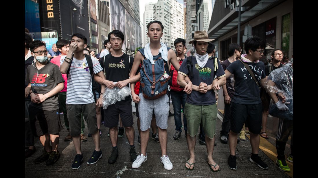 Pro-democracy demonstrators protect a barricade from "anti-Occupy" crowds in Hong Kong on October 3.