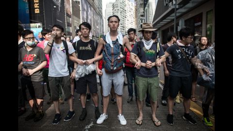 Pro-democracy demonstrators protect a barricade from "anti-Occupy" crowds in Hong Kong on October 3. 