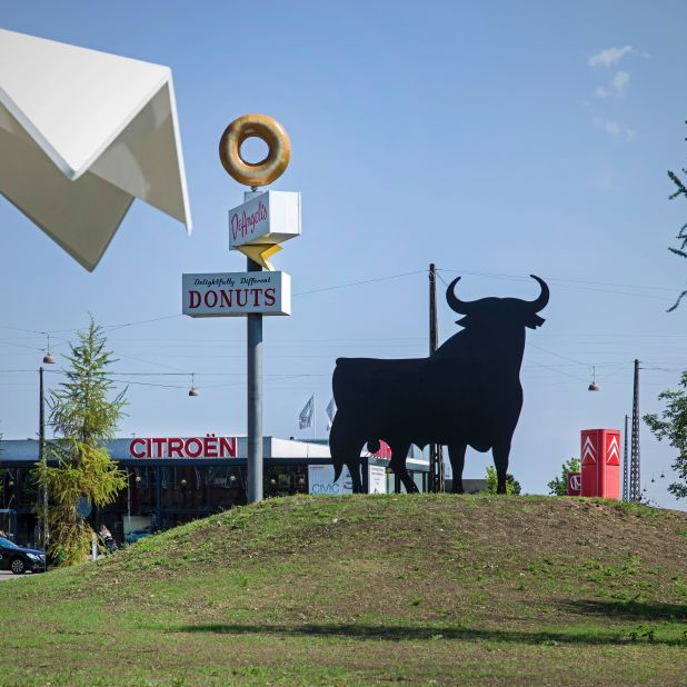 Superkilen is filled with eclectic items from around the world, including an American "Donut" sign and a Spanish bull.