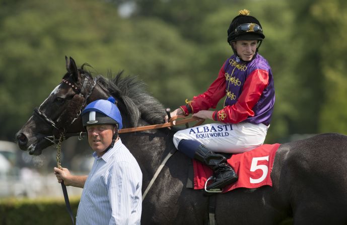Here, Witheford leads one of Queen Elizabeth II's race horses, Purple Spectrum.