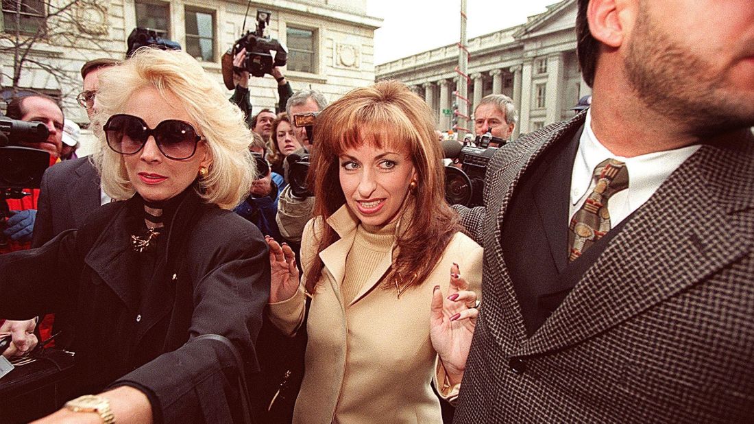 Paula Jones, center, arrives at the office of a lawyer representing Clinton in January 1998. The former Arkansas state employee filed a federal civil lawsuit in 1994 accusing Clinton of making "persistent and continuous" unwanted sexual advances during a conference in 1991, when he was governor. The President agreed to an $850,000 settlement in November 1998.