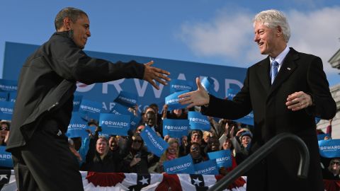 Clinton welcomes President Barack Obama to the stage during a campaign rally in New Hampshire in November 2012.