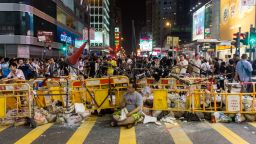 A man sits in front of a barricade built by pro-democracy protestors on October 4 in the Kowloon district of Hong Kong.