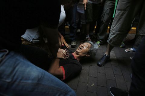 Pro-democracy student protesters pin a man to the ground after an assault during a scuffle with local residents in Mong Kok on October 4. 