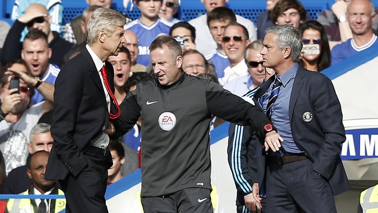 Arsene Wenger and Jose Mourinho have to be separated by fourth official Jonathon Moss in the EPL clash at Stamford Bridge.