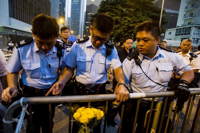 Police officers remove barriers outside government offices in Hong Kong on Sunday, October 5.