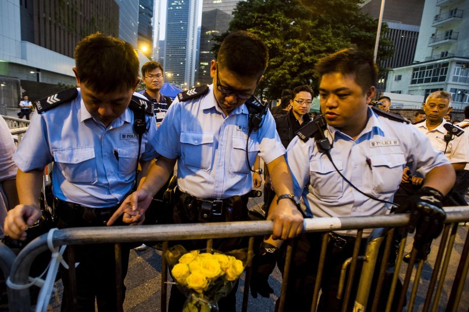 Police officers remove barriers outside government offices in Hong Kong on Sunday, October 5.