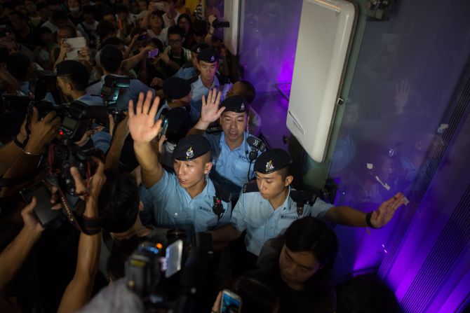 Pro-democracy demonstrators surround police October 5 in the Mong Kok district of Hong Kong.