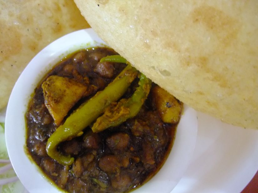 Chola bhatura is a meal on its own. It's a fluffy, plain-flour bread combined with a chickpea curry, garnished with chopped onion and served with a tangy mango pickle.