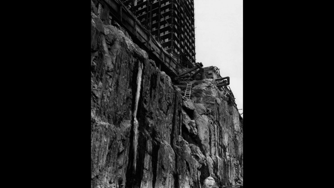 <strong>Berenice Abbott</strong><br /><br />In another photo from her project "Changing New York" her camera is trained on a wild-looking cliff face which appears alien to the city growing around it.<br /><br />It is actually a site on Fifth Avenue and the deep foundations of what would become the Art Deco Rockefeller Center.