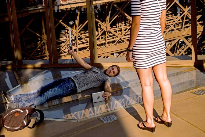 Visitors are lining up -- and lying down -- to experience the Eiffel Tower's new glass floor.