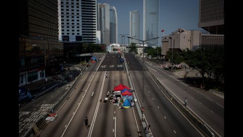 Protesters walk up an empty street inside the protest site near Hong Kong's government complex on October 7.